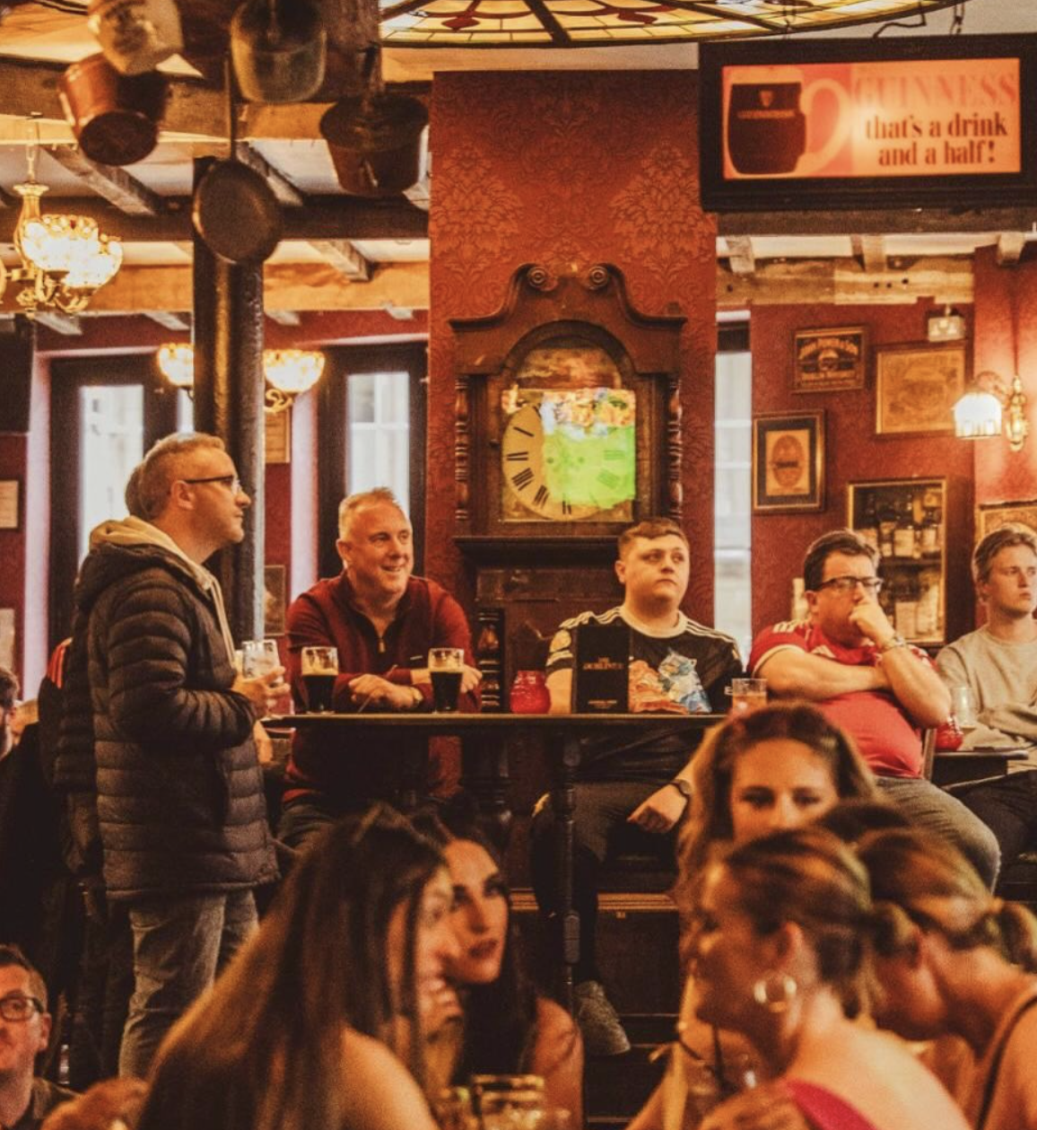 Fans cheering a match at the pub